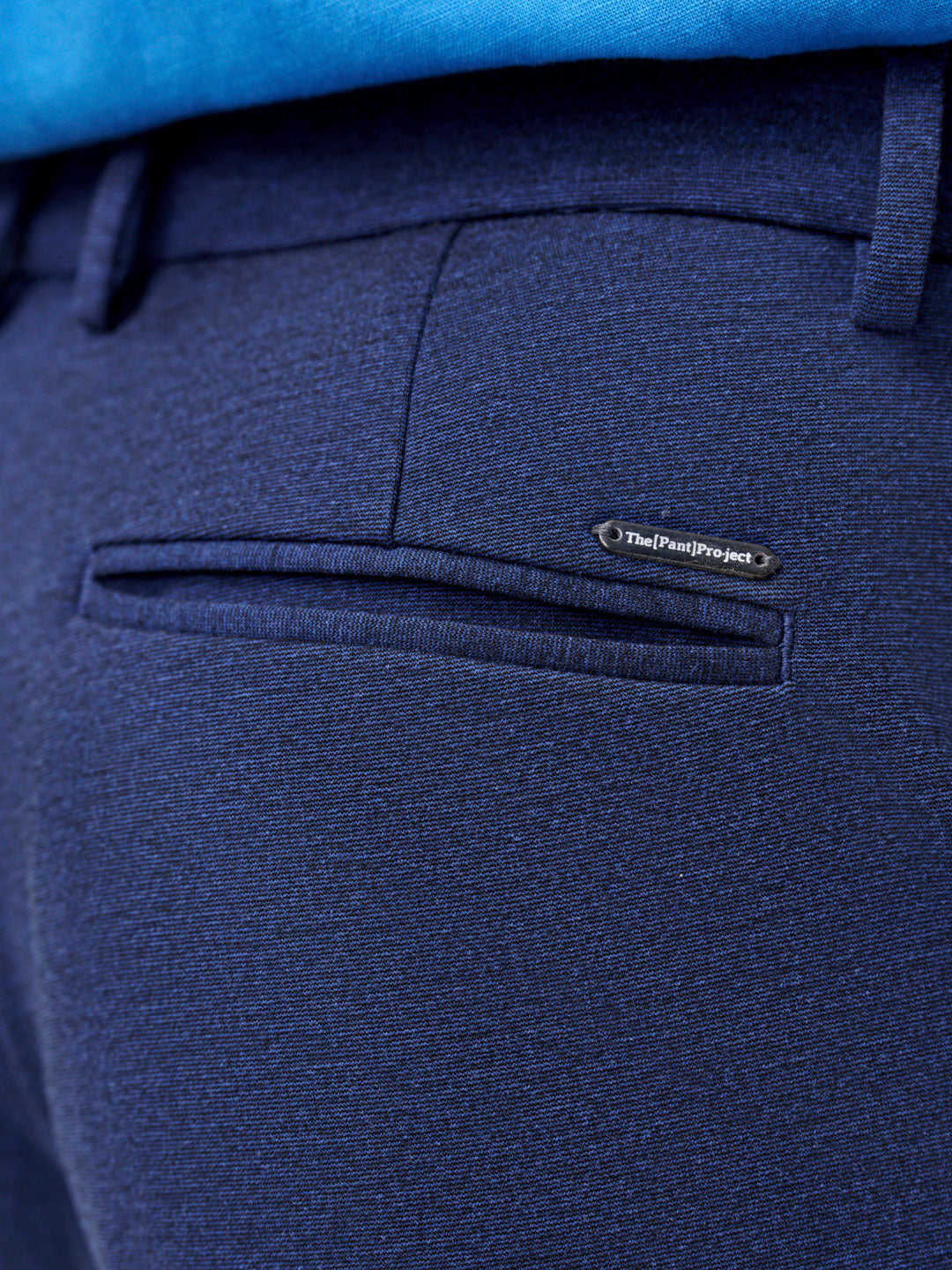 close view of back pocket and logo detail on insignia blue pants by the Pant Project