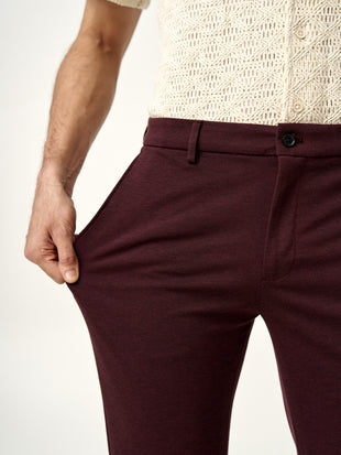 close view of the stretch fabric on plum wine trousers by the Pant Project
