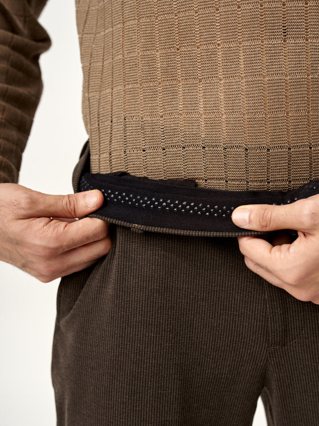 close view of the waistband and brown textured fabric of walnut brown pants by the Pant Project