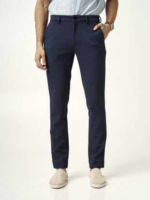 front view of man standing in the Pant Project sail blue pants with hands in pockets