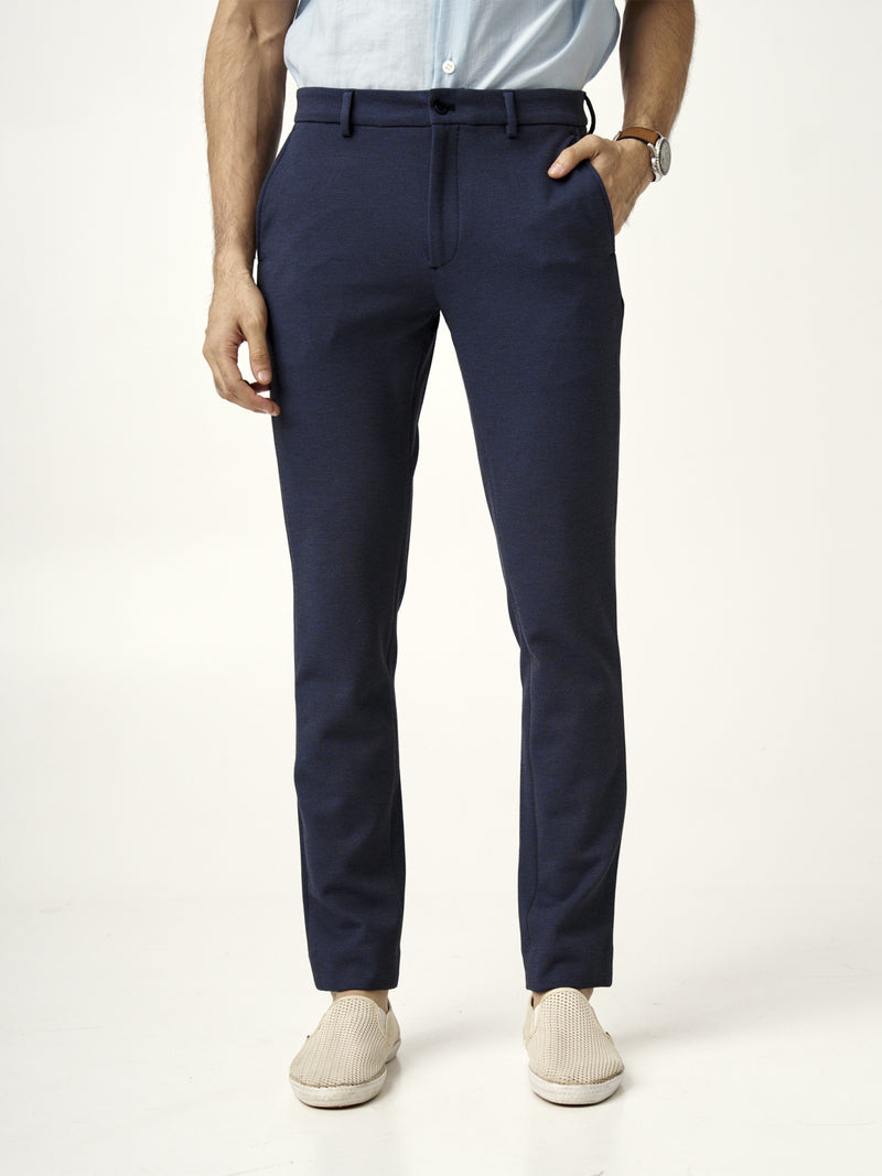 front view of man standing in the Pant Project sail blue pants with hands in pockets