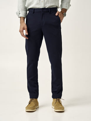front view of man wearing dark navy custom pants by the Pant Project paired with beige shoes