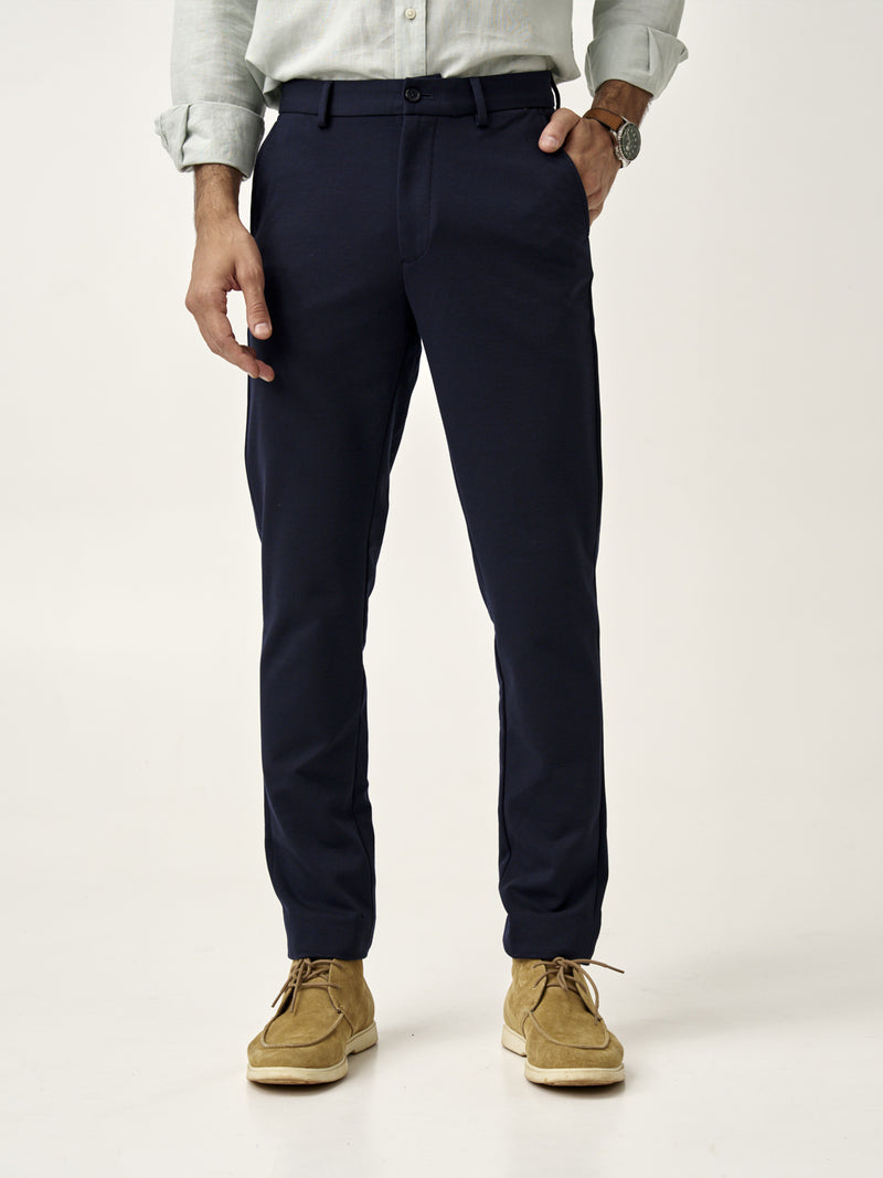 front view of man wearing dark navy custom pants by the Pant Project paired with beige shoes
