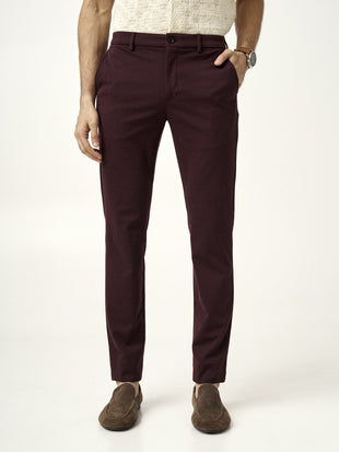 front view of plum wine trousers worn by model by the Pant Project