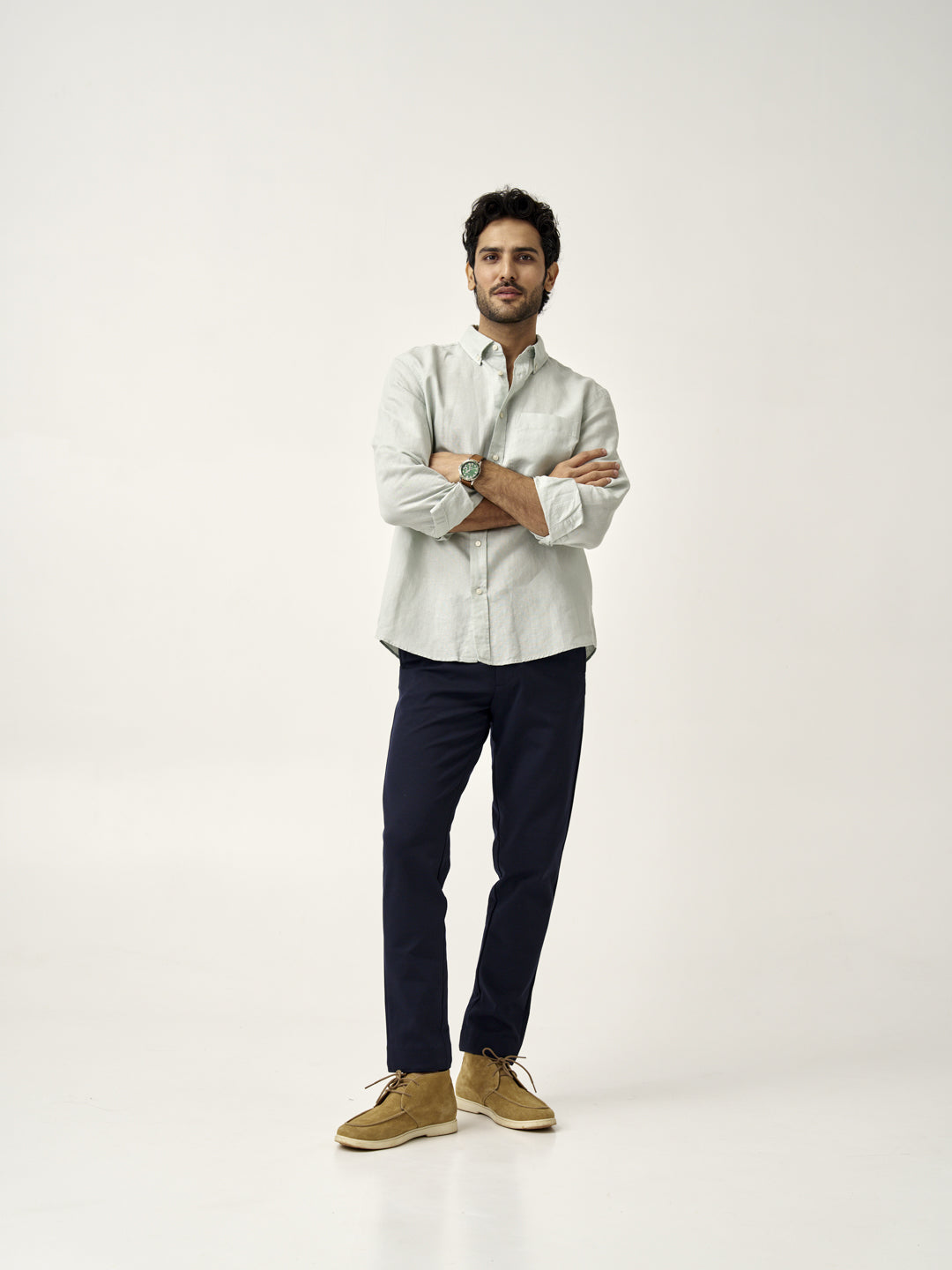 full body shot of man in dark navy custom pants by the Pant Project with light green shirt