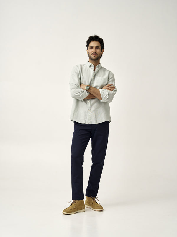 full body shot of man in dark navy custom pants by the Pant Project with light green shirt