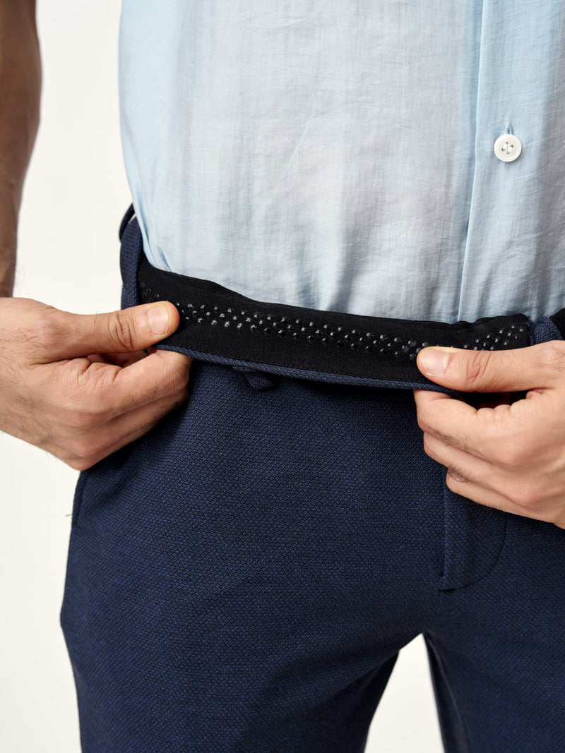 holding waistband of sail blue pants from the Pant Project with inner grip detail
