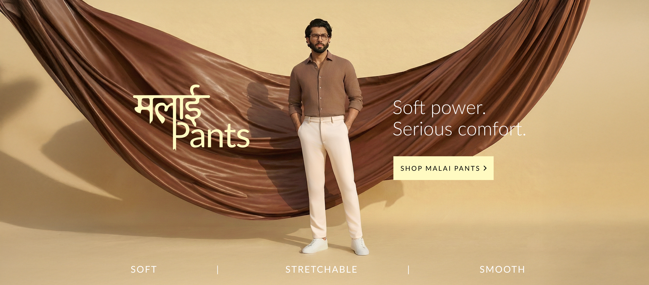 Man wearing a brown shirt and white pants with text about Malai Pants on a beige background