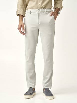 man adjusts matcha green pants from the Pant Project with hands in pockets
