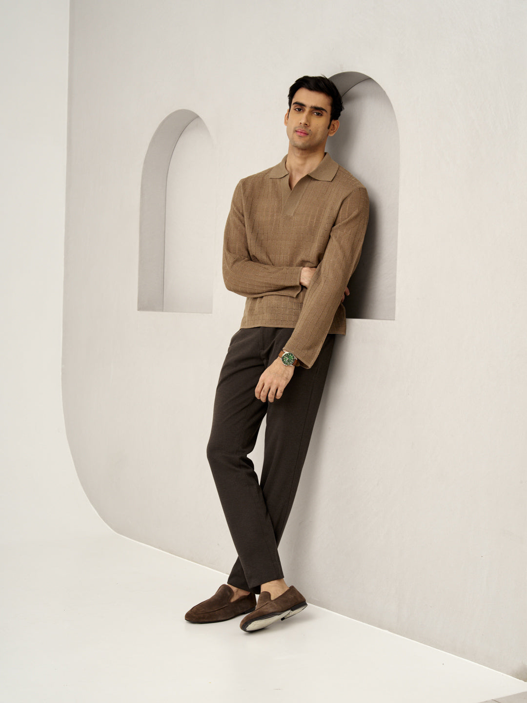 man in relaxed pose wearing walnut brown pants by the Pant Project, paired with loafers