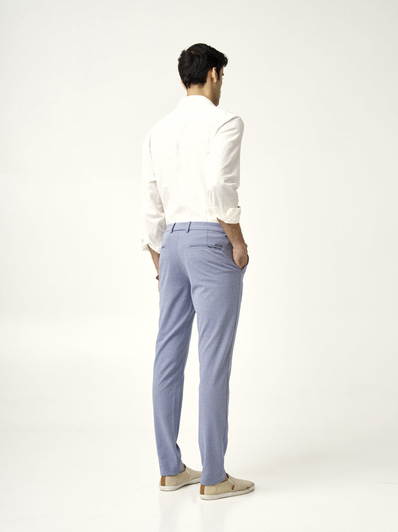 rear view of a man wearing scottish blue pants and a white shirt from the Pant Project