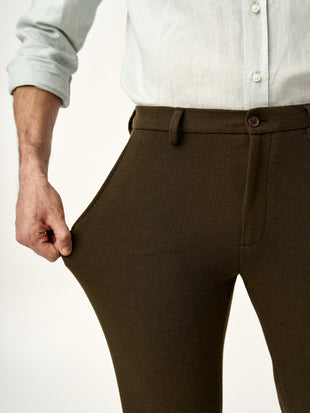 showing the stretchable fabric of dark brown oliver texture pants from the Pant Project