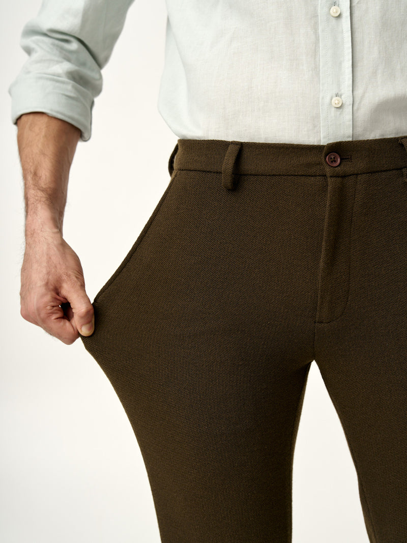 showing the stretchable fabric of dark brown oliver texture pants from the Pant Project