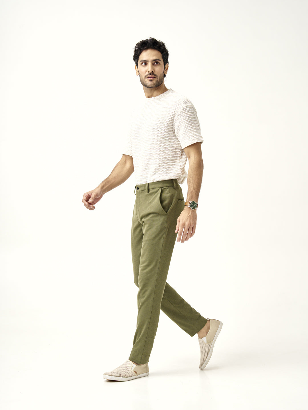 side profile view of military green pants styled with white slip-on shoes by the Pant Project
