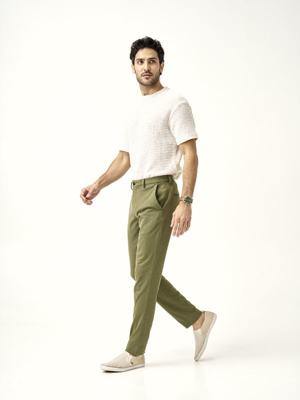 side profile view of military green pants styled with white slip-on shoes by the Pant Project