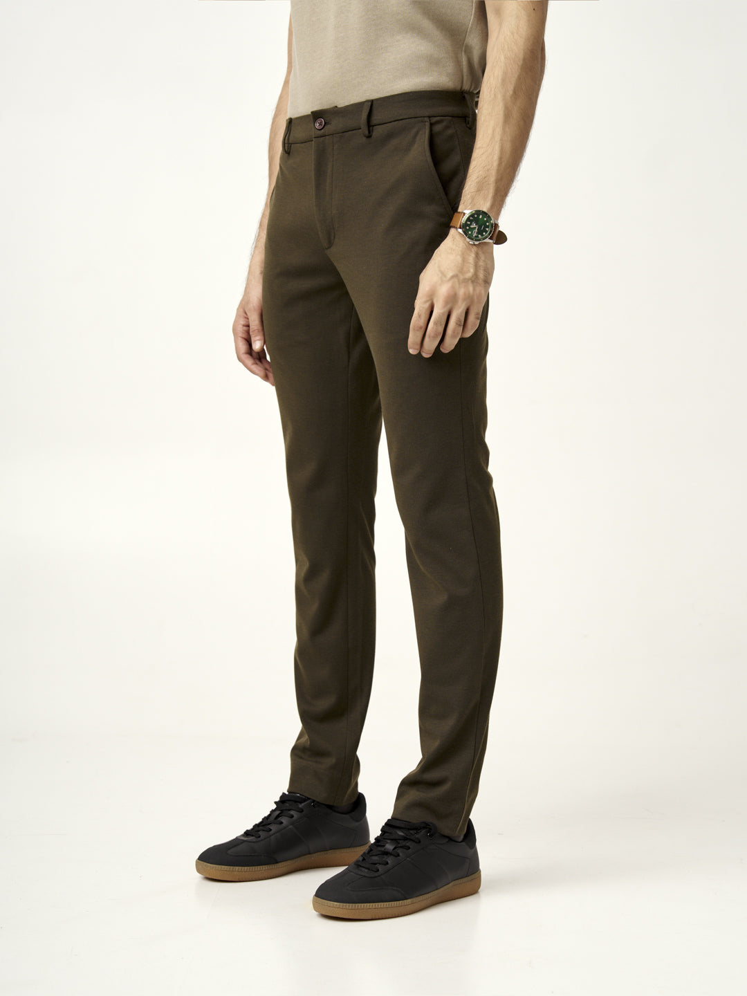 side view of martini olive pants styled with a beige t-shirt by the Pant Project