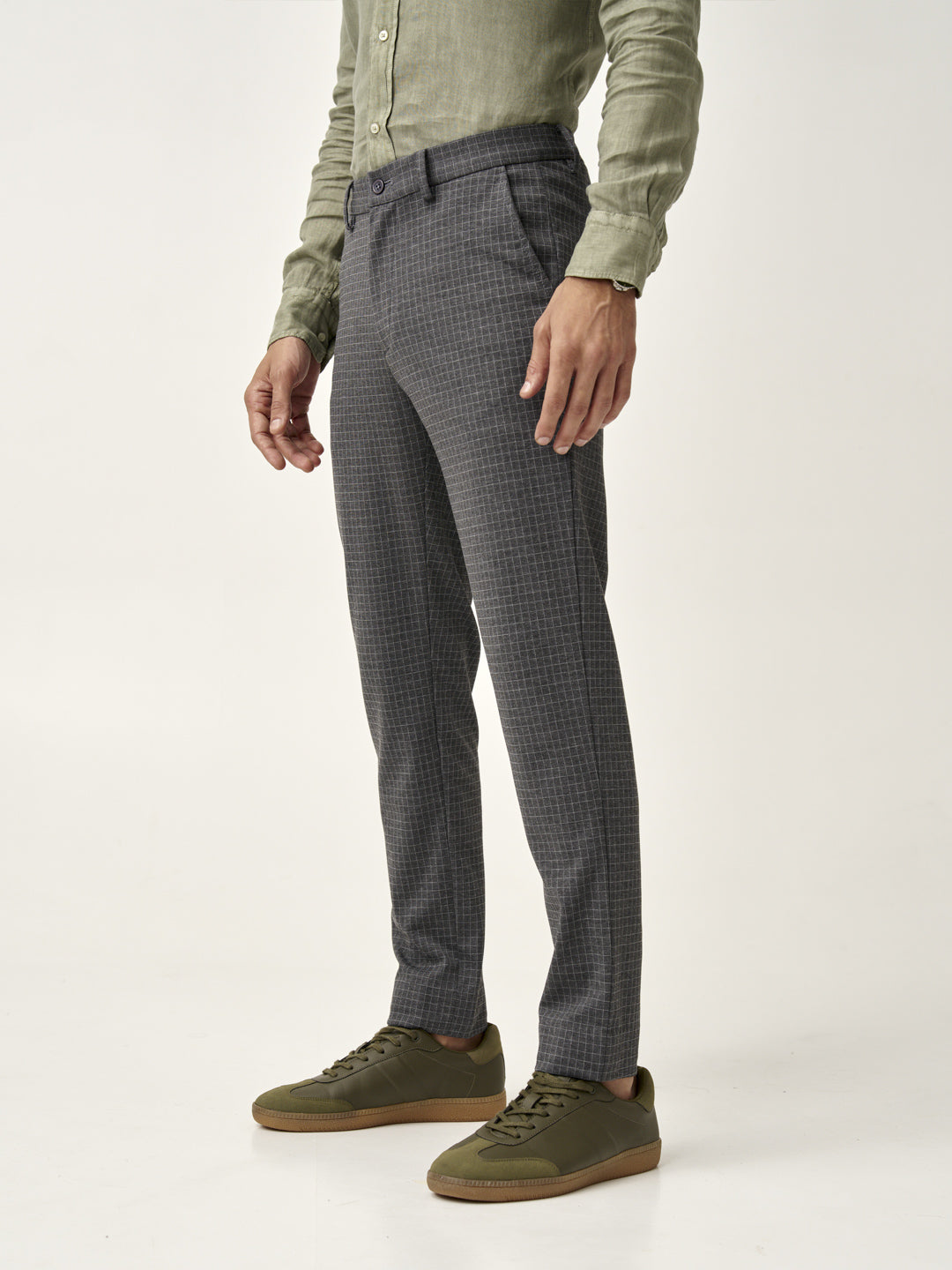 side view with green sneakers of man wearing grey check pants from the Pant Project