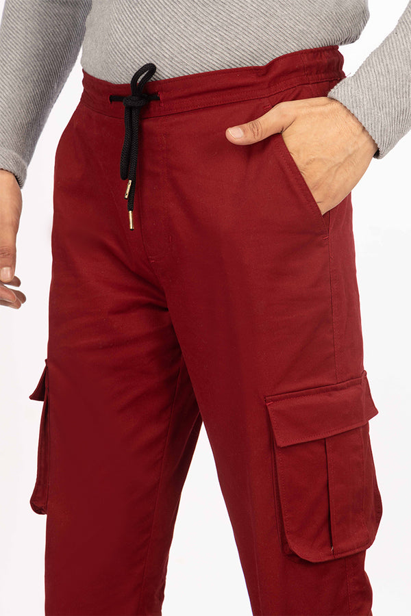 side view of red cargo pant by pant project with pocket details