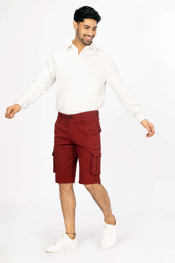 front view of red cargo shorts by pant project featuring pocket details