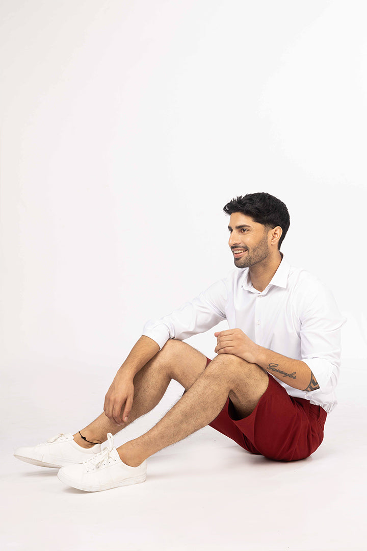 seated view of red chino shorts by pant project casual style