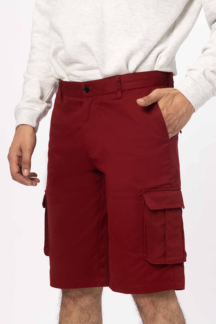 front view of red cargo shorts by pant project with pocket details