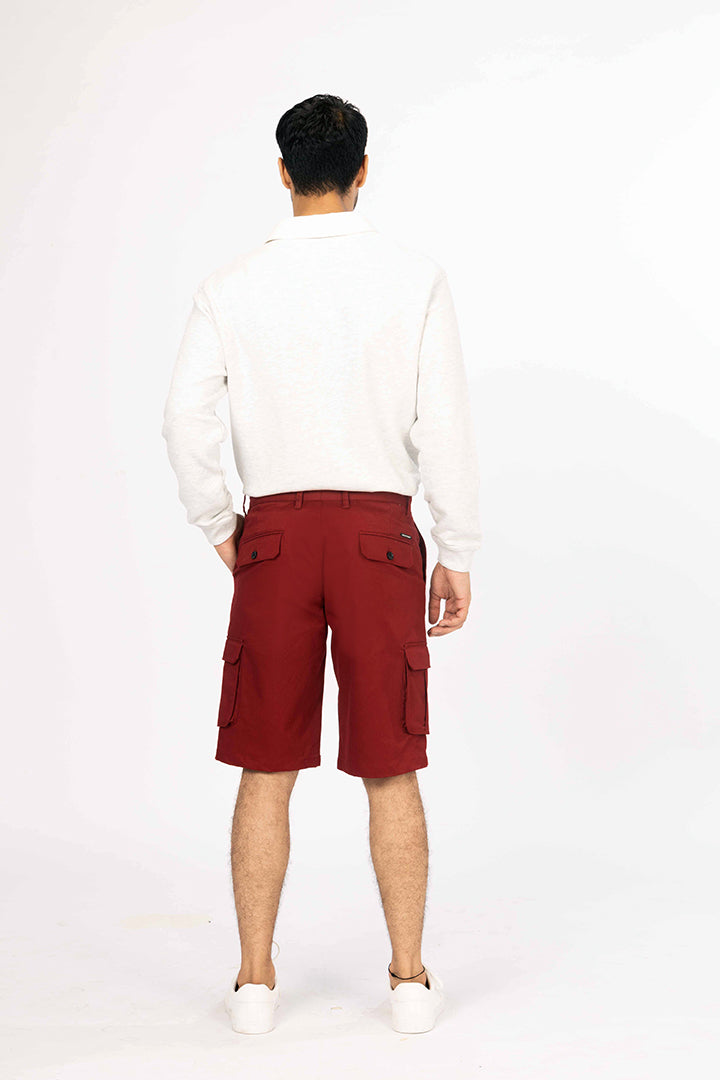 back view of red cargo shorts by pant project with pocket details